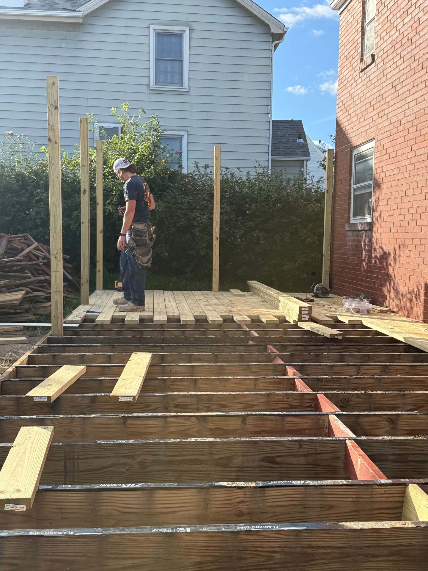 Deck boards being installed over the existing framing
