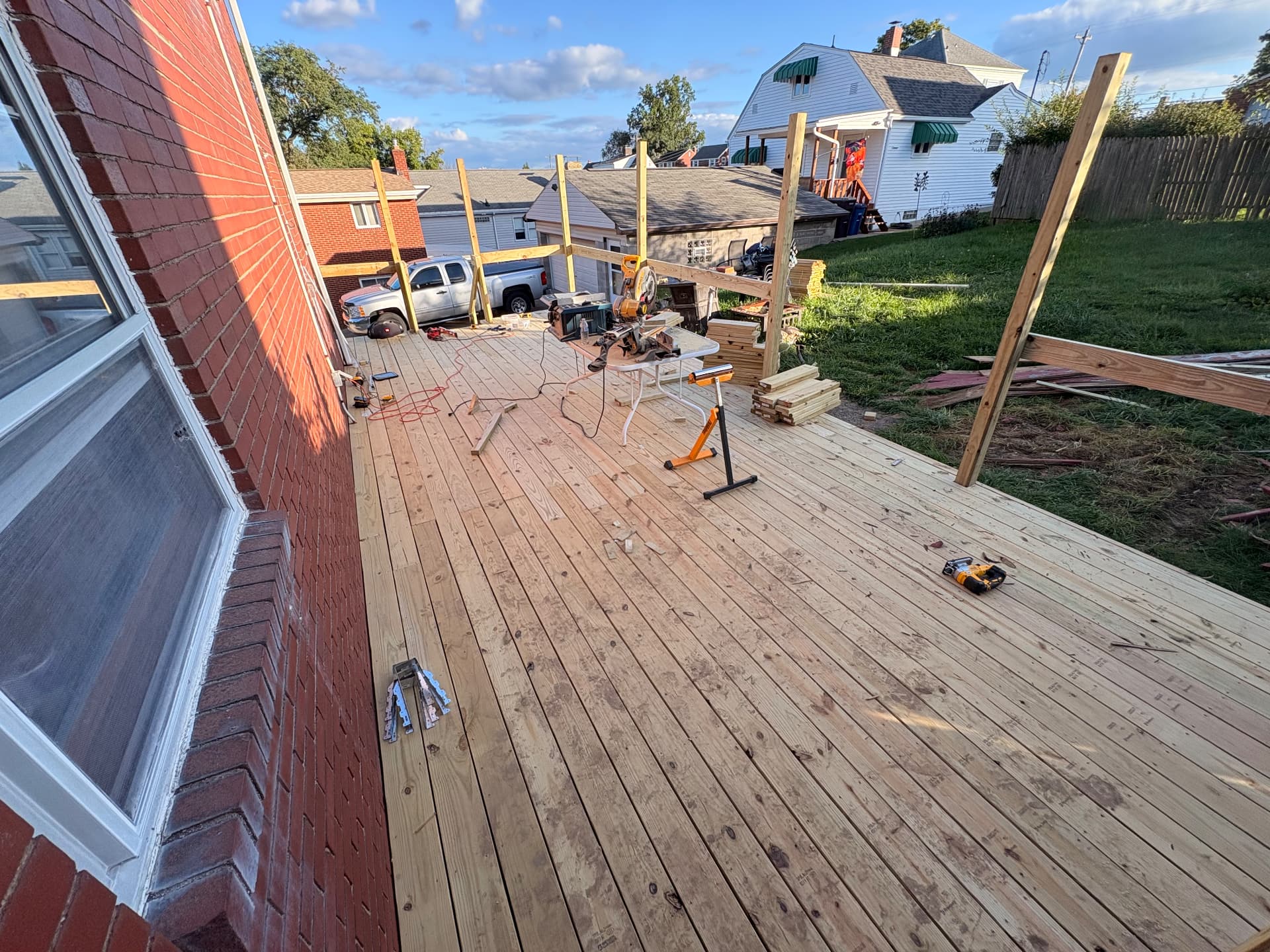 New deck boards and posts beside the brick home