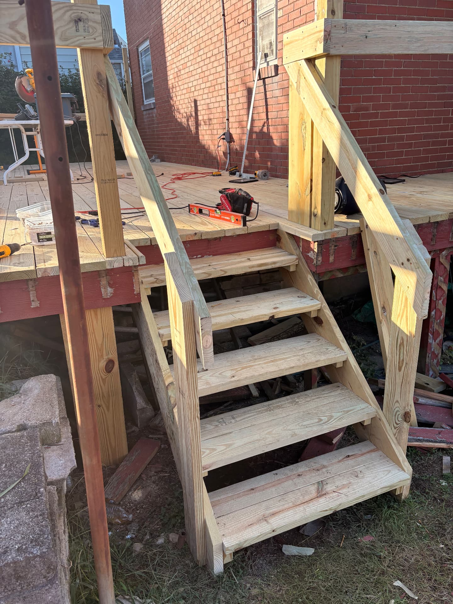 New wood stairs and handrails leading up to the deck