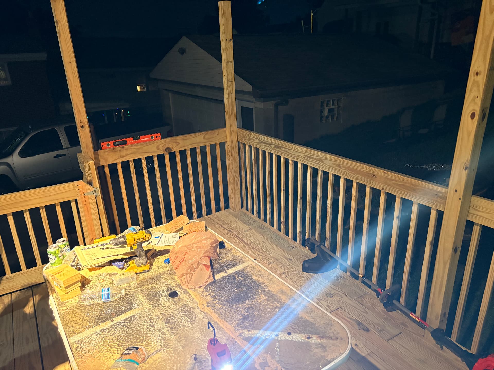 Deck railing installation continuing into the evening